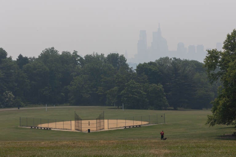 View of the Philadelphia skyline from a park, obscured by smoke