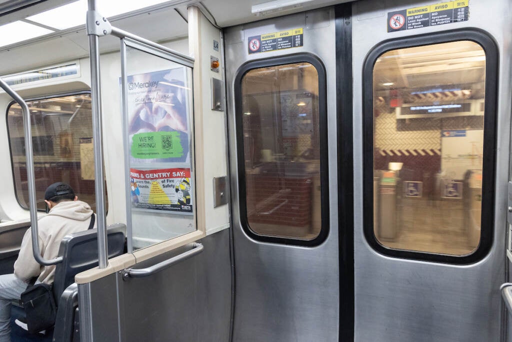 A person sits on the SEPTA subway.