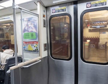 A person sits on the SEPTA subway.