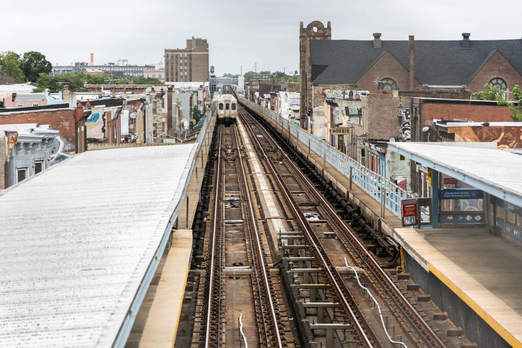 The elevated train tracks and the city skyline.