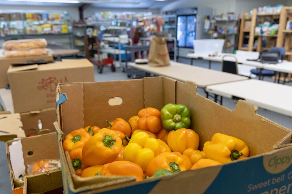 Bell peppers sit in a cardboard box.