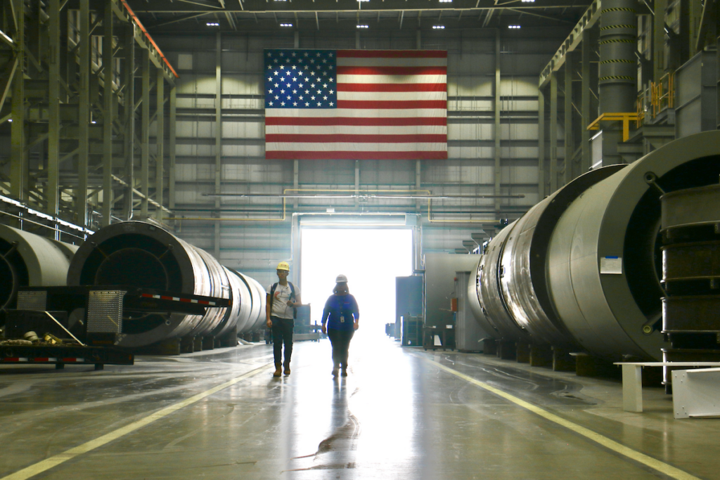 Joy Russell, Holtec's Senior Vice President and Chief Commercial Officer, gives a tour of the company's Camden plant, which manufactures spent fuel storage and transportation modules for nuclear plants around the world. (Emma Lee/WHYY)