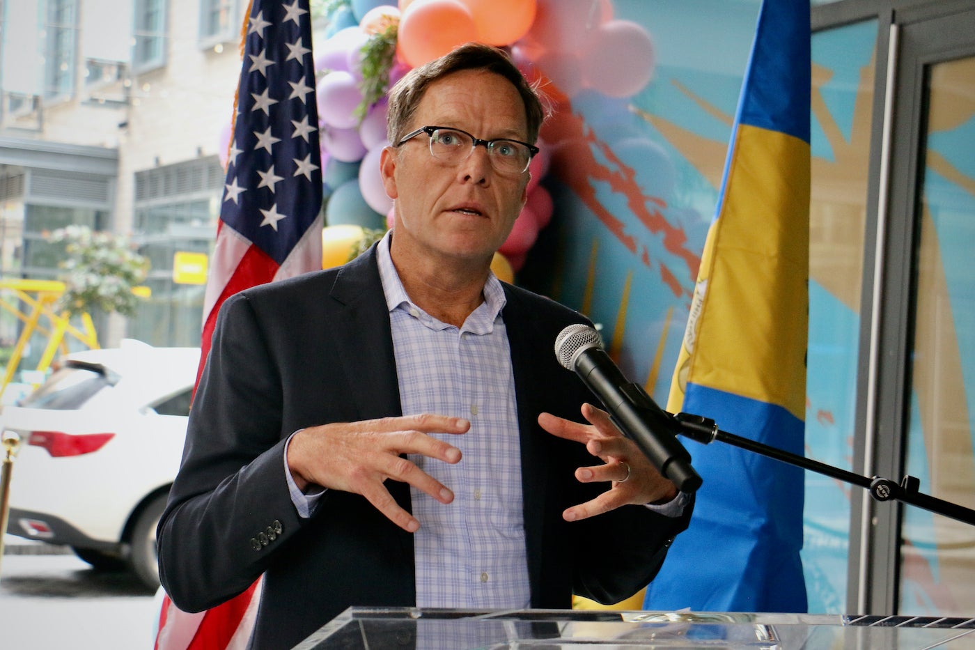 Daniel Killinger, president of National Real Estate Development, speaks at the ceremonial opening of Jefferson Plaza, a 12,000-square-foot public outdoor space that connects Market and Chestnut streets. (Emma Lee/WHYY)