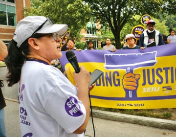 Office cleaner Marcelina Lemus of Norristown speaks out against Planned Companies' use of non-union workers at a union rally in Conshohocken. (Emma Lee/WHYY)