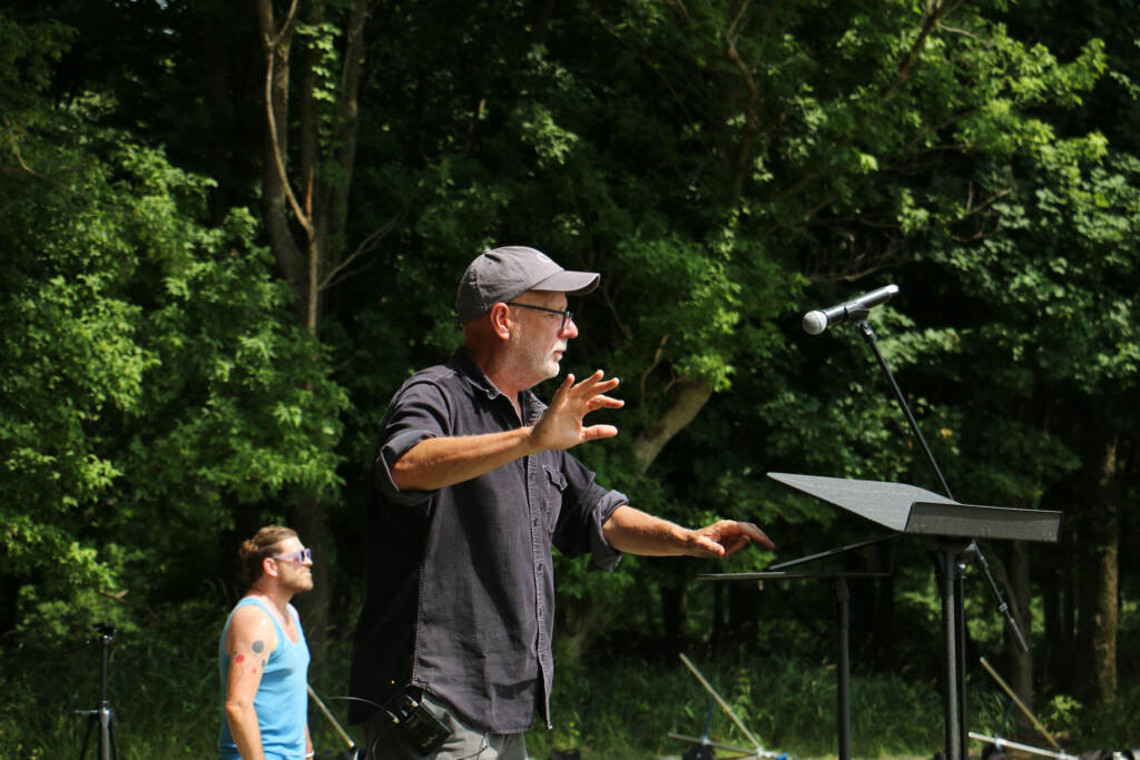 Donald Nally conducts a choir.