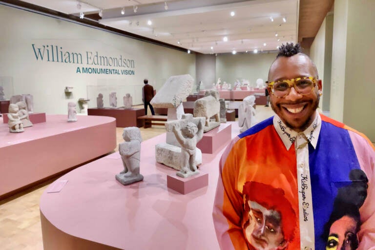 James Claiborne poses in front of the gallery at the Barnes Foundation where William Edmondson's sculptures are displayed.