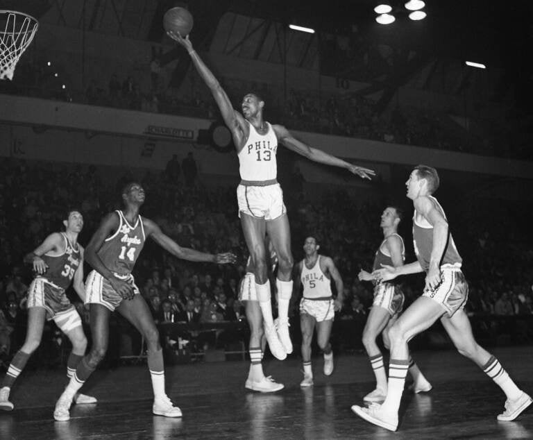 Wilt Chamberlain, the towering Philadelphia Warriors center, stretches for a basket against the Los Angeles Lakers, Feb. 28, 1961 at the Philadelphia Arena