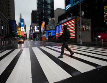 FILE - A man crosses the street in a nearly empty Times Square, devoid of the usual weekday morning crowds, March 23, 2020, in New York. In May 2023, U.S. Surgeon General Vivek Murthy declared loneliness an American epidemic. While solitude and isolation do not automatically equal loneliness, Murthy’s report found, people tightened their groups of friends and cut time spent with them during the pandemic. According to the report, Americans spent 20 minutes a day with friends in 2020 — down from an hour daily two decades ago. (AP Photo/Mark Lennihan, File)