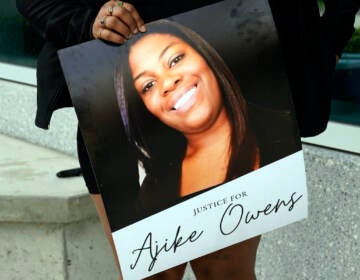 A protester, holds a poster of Ajike Owens at the Marion County Courthouse, Tuesday, June 6, 2023, in Ocala, demanding the arrest of a woman who shot and killed Owens, a 35-year-old mother of four, last Friday night, June 2. Authorities came under intense pressure Tuesday to bring charges against a white woman who killed Owens, a Black neighbor, on her front doorstep, as they navigated Florida’s divisive stand your ground law that provides considerable leeway to the suspect in making a claim of self defense
