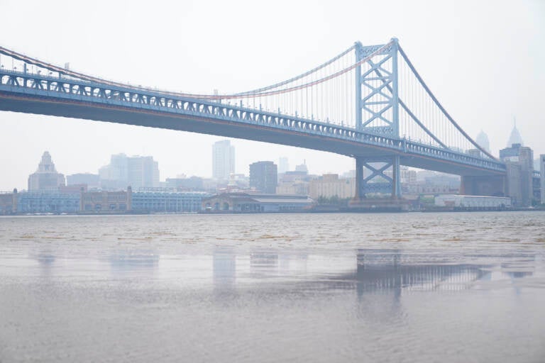 The Benjamin Franklin Bridge and the Philadelphia skyline are shrouded in haze, Wednesday, June 7, 2023. Intense Canadian wildfires are blanketing the northeastern U.S. in a dystopian haze, turning the air acrid, the sky yellowish gray and prompting warnings for vulnerable populations to stay inside.