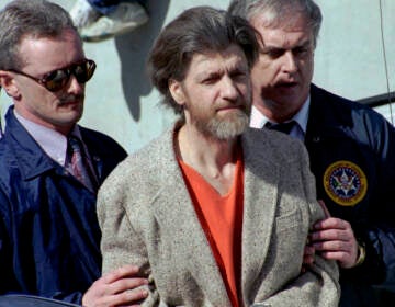 In this April 4, 1996 file photo, Ted Kaczynski, better known as the Unabomber, is flanked by federal agents as he is led to a car from the federal courthouse in Helena, Mont.  Kaczynski, known as the “Unabomber,” has died in federal prison, a spokesperson for the Bureau of Prisons told The Associated Press on Saturday, June 10, 2023. (AP Photo/John Youngbear, File)
