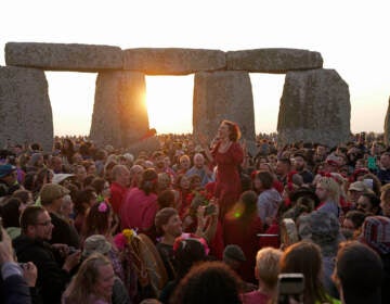 Revelers gather at the ancient stone circle Stonehenge to celebrate the Summer Solstice, the longest day of the year, near Salisbury, England, Wednesday, June 21, 2023. Druids, pagans, hippies, local residents, tourists and costumed witches and wizards have gathered around a prehistoric stone circle on a plain in southern England to express their devotion to the sun