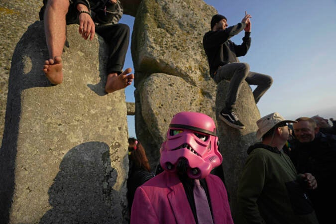 Revelers gather at the ancient stone circle Stonehenge to celebrate the Summer Solstice, the longest day of the year, near Salisbury, England, Wednesday, June 21, 2023. (AP Photo/Kin Cheung)