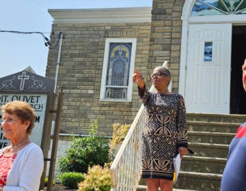 C. Adrienne Rhodes, co-founder of the Preserving Black Haddonfield History Project, stands on the steps of Mount Olivet Baptist Church and Parsonage in Haddonfield, N.J., on June 19, 2023. (Nicole Leonard/WHYY)