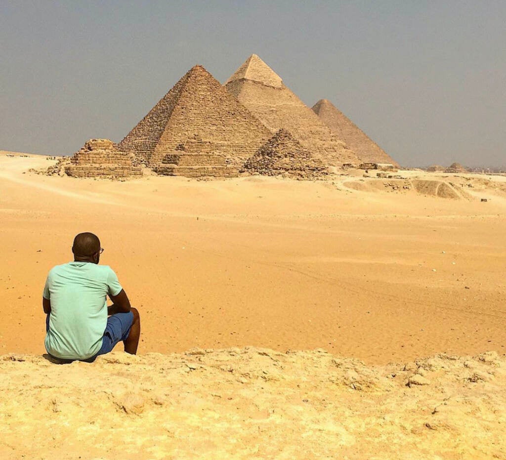 Lawrence Phillips sitting looking at the pyramids.