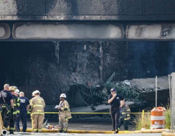 Crews work to contain a tanker fire underneath an Interstate 95 overpass in Philadelphia on Sunday, June 11, 2023