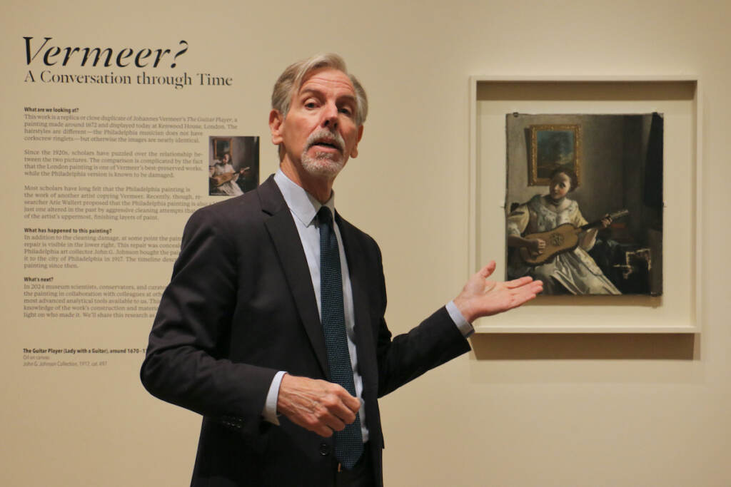 Mark Tucker, director of conservation at the Philadelphia Museum of Art, gestures toward a painting