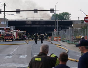 First responders work to extinguish a vehicle fire, Sunday June 11, 2023, that caused an overpass on I-95 to collapse near the Cottman Avenue exit