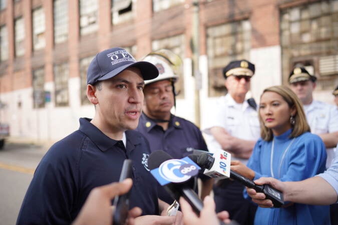 Philadelphia OEM Director Dominick Mireles (left) speaks with members of the news media, Sunday June 11, 2023, after a vehicle fire caused an overpass on I-95 to collapse near Cottman Avenue