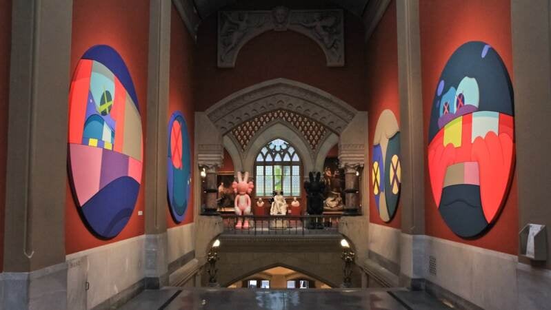 KAWS @ PAFA features six tondos, or round paintings featured in the sky-lit central gallery. KAWS said he was inspired by the symmetry of the space.(Kimberly Paynter/WHYY)