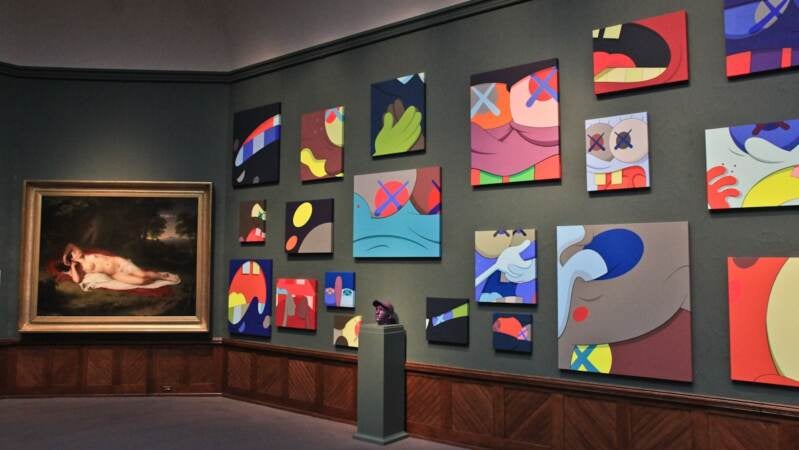42 of KAWS painting mimic the historical paintings across the room in PAFA's Gallery 6. (Kimberly Paynter/WHYY)