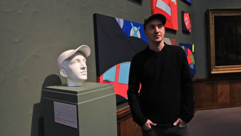 Artist KAWS and a sculpture of himself he said is 