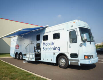 The SKCC and Dietz Watson Mobile Cancer Screening van is visible parked outside on a sunny day.