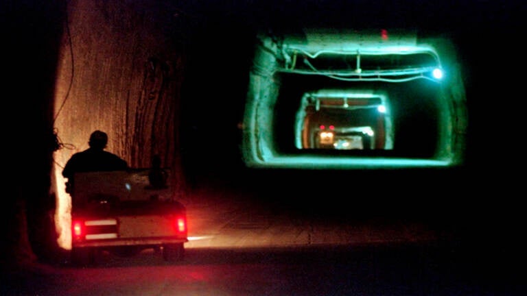 A worker drives cart through a tunnel inside a radioactive waste storage facility in New Mexico. The underground repository was created to house nuclear waste created by decades of research and bomb-making. (AP Photo/Eric Draper, File)