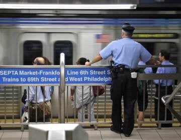 A transit police officer keeps watch on the Market-Frankford line.
