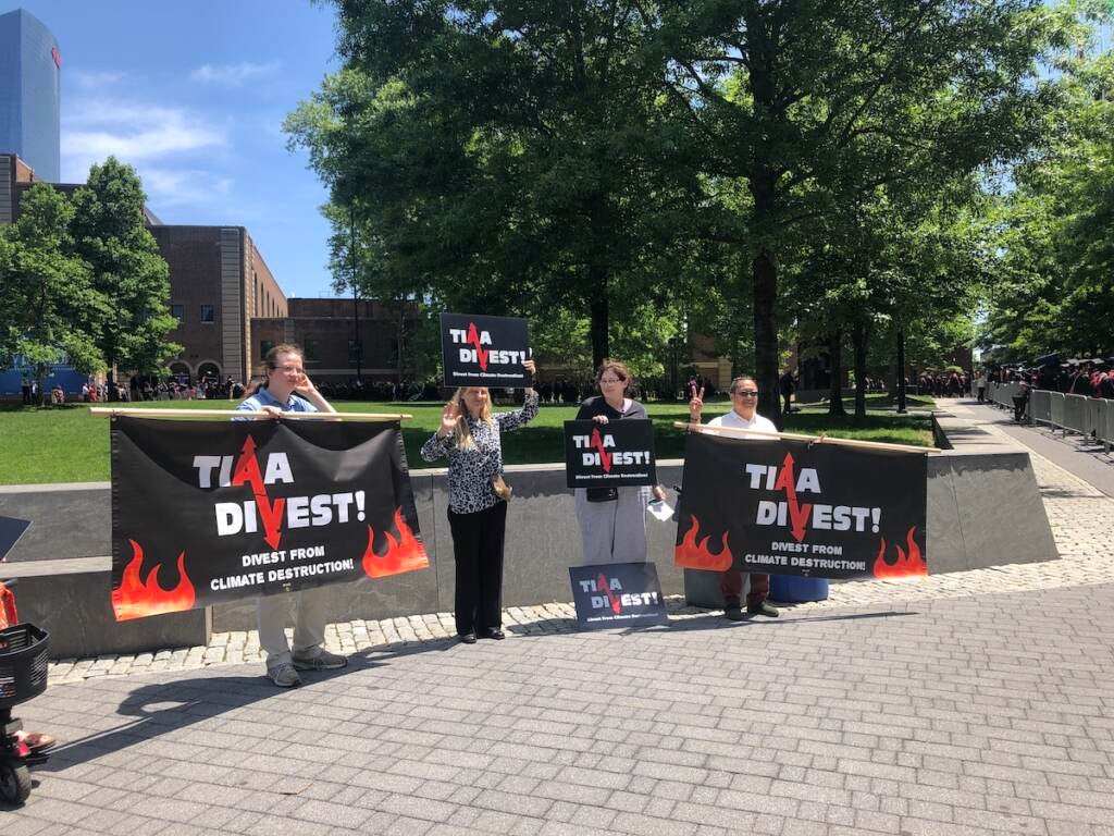 Climate activists hold signs