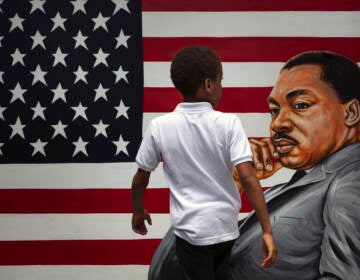 A young boy walks past a painting depicting Dr. Martin Luther King Jr. during a Juneteenth celebration in Los Angeles in 2020. Juneteenth marks the day in 1865 when federal troops arrived in Galveston, Texas, to take control of the state and ensure all enslaved people be freed, more than two years after the Emancipation Proclamation.