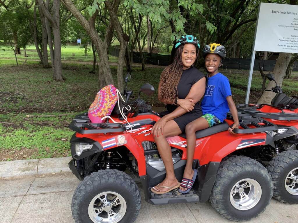 Tomika and Solomon Anderson sitting on an ATV.