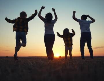 friendly family jumping rejoice. silhouette a happy family bouncing with happiness after victory in nature sunset. happy family kid dream freedom concept. big family happy freedom in nature lifestyle