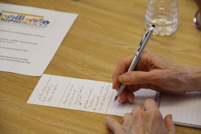 An up-close view of a person writing something on a piece of paper.