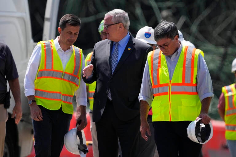 Transportation Secretary Pete Buttigieg, left, meets with Philadelphia Mayor Jim Kenney at the scene of a collapsed elevated section of I-95