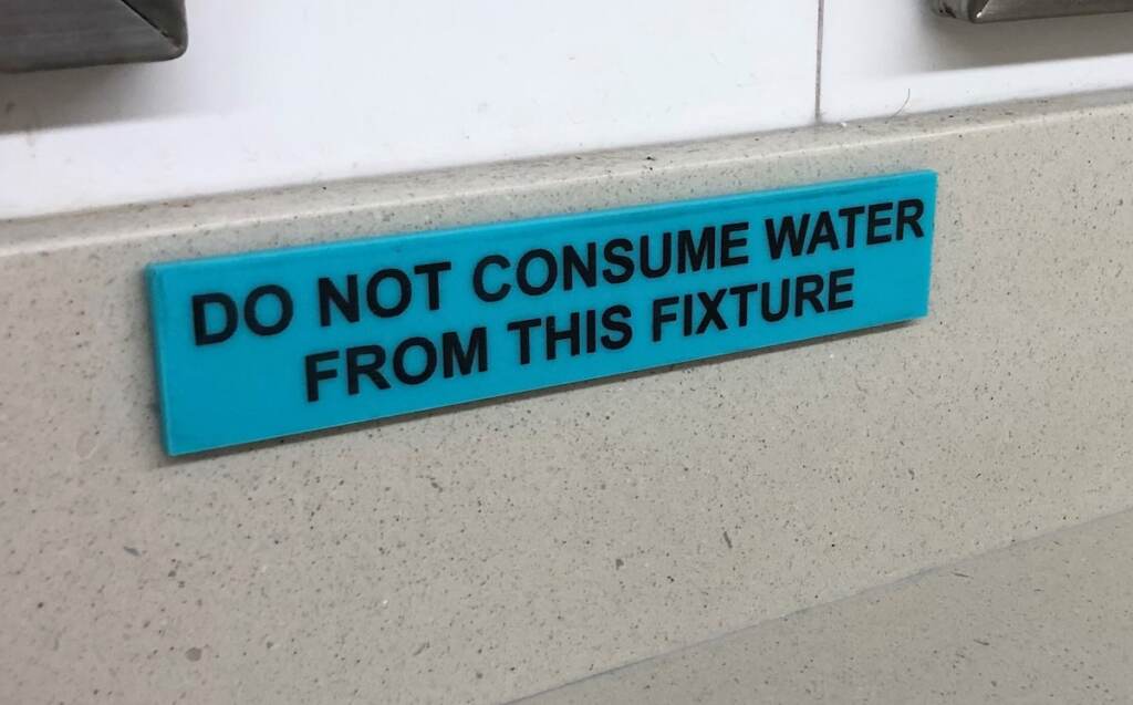 A sign reads "Do not consume water from this fixture."