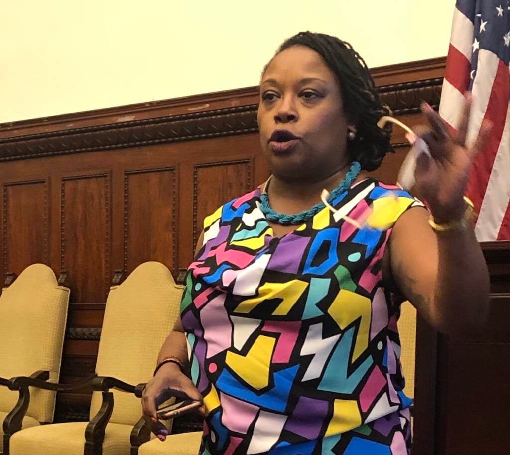 Erica Atwood gestures as she speaks at a meeting at City Hall.