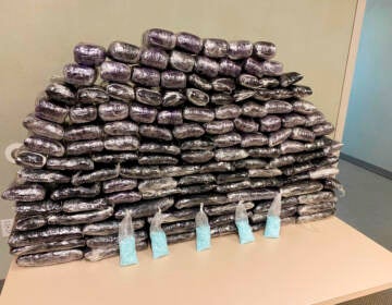 A number of fake fentanyl pills seized by DEA are displayed in a pile.