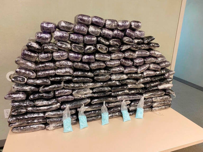 A number of fake fentanyl pills seized by DEA are displayed in a pile.