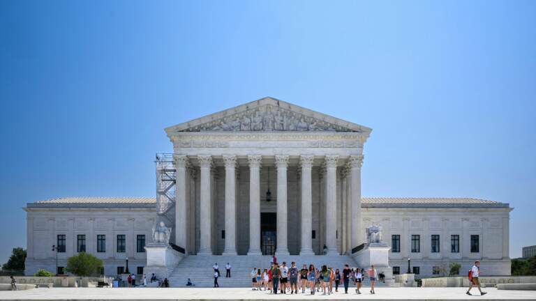 The U.S. Supreme Court building is visible on a sunny day.