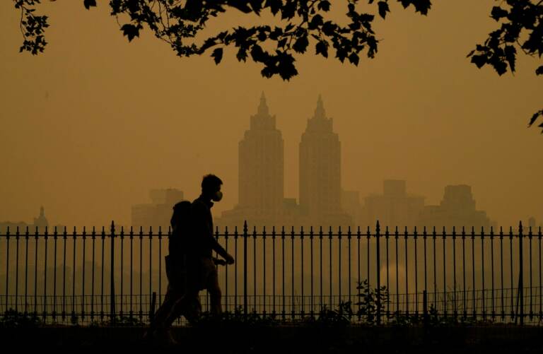People walk in Central Park as smoke from wildfires in Canada cause hazy conditions in New York City