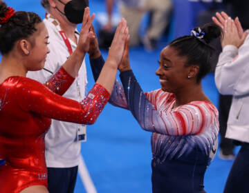 Sunisa Lee and Simone Biles of Team USA during the Women's Balance Beam Final at the Tokyo 2020 Olympic Games in Aug. 2021