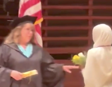 Graduation ceremony, with student getting denied a diploma.