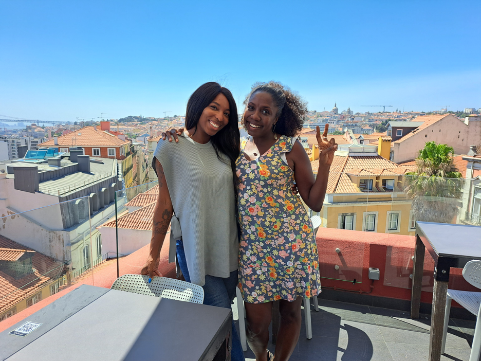 Twanna Hines and Anna Sanders posing on a rooftop.