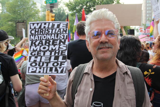 Robert Perry holds up a sign that reads 