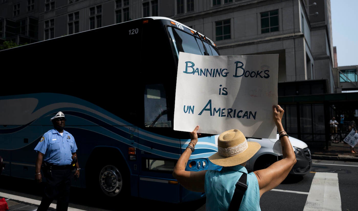 Protester on the street holding a sign that says 'Banning Books is UnAmerican'