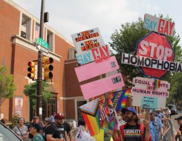 Protesters brought signs to a Thursday action decrying this weekend's Moms For Liberty Summit in Philadelphia