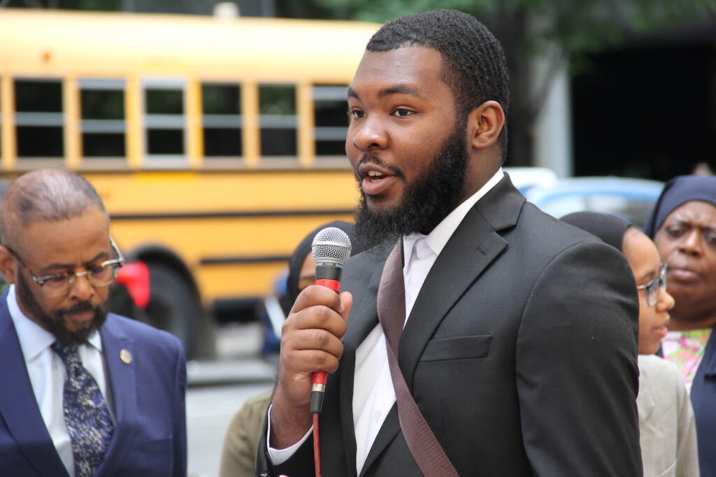 George Lane speaking into a microphone