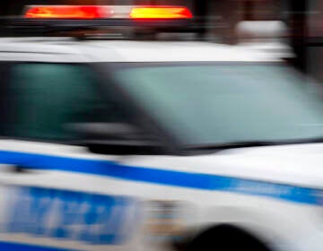 A blurred image of an NYPD police car in motion.