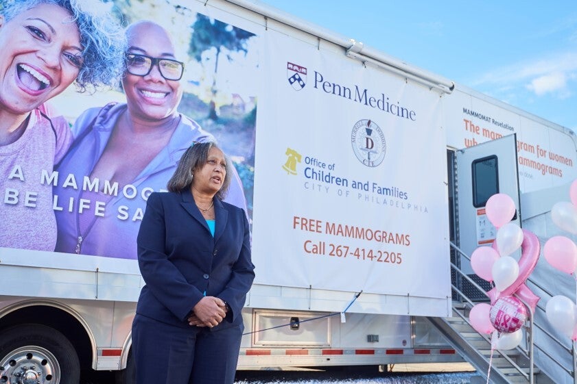 Linda White Nunes at an event in front of a mobile mammogram screening truck.